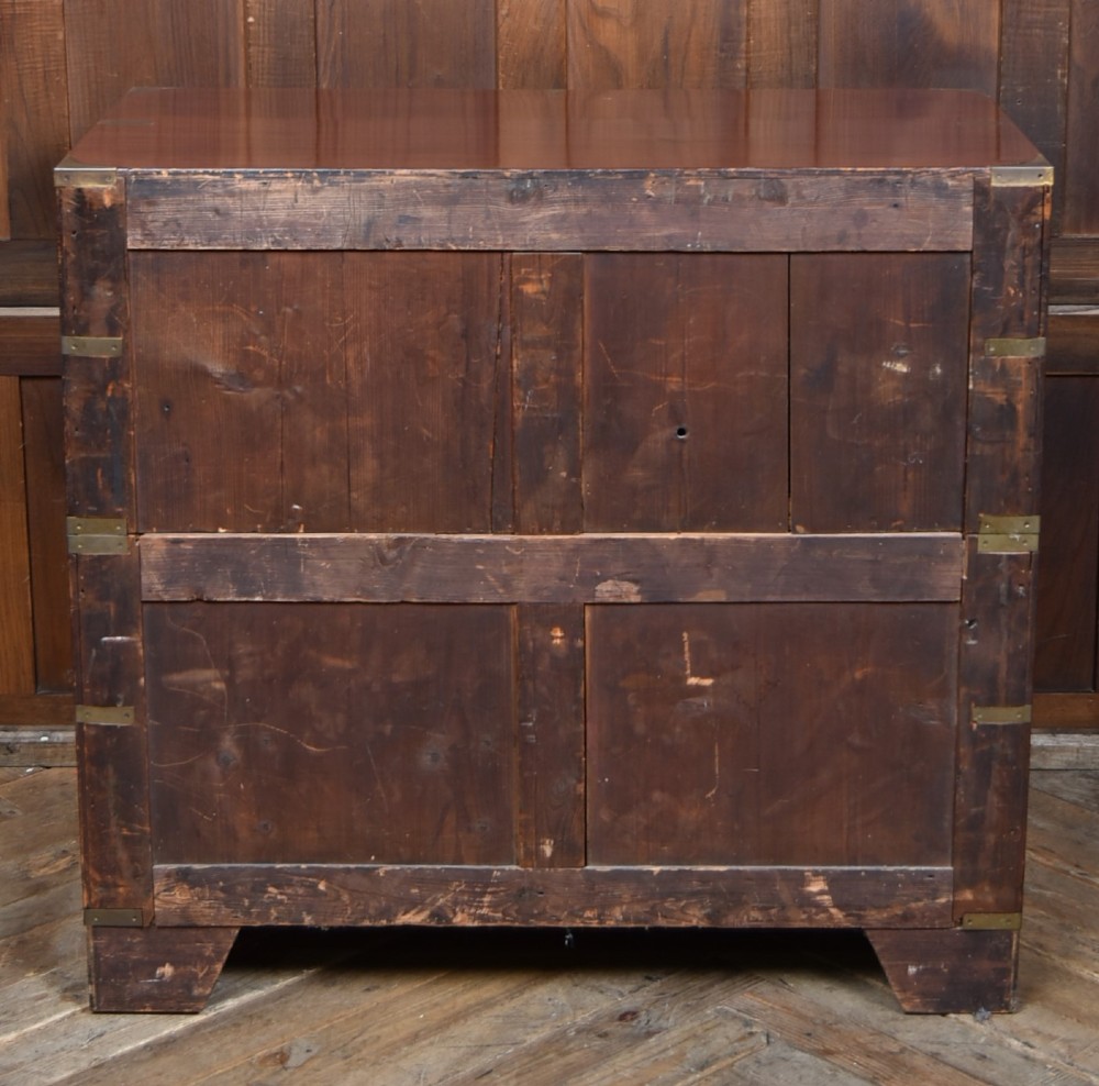 A 19th-century mahogany campaign chest of drawers featuring flush brass handles, corner brackets, and a two-section design. View VII