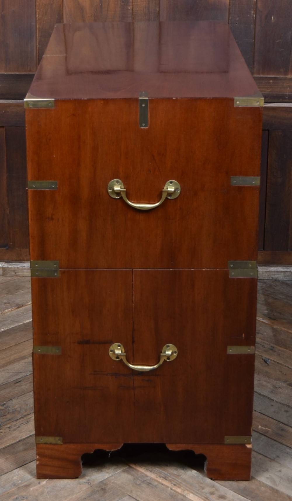 A 19th-century mahogany campaign chest of drawers featuring flush brass handles, corner brackets, and a two-section design. View VIII