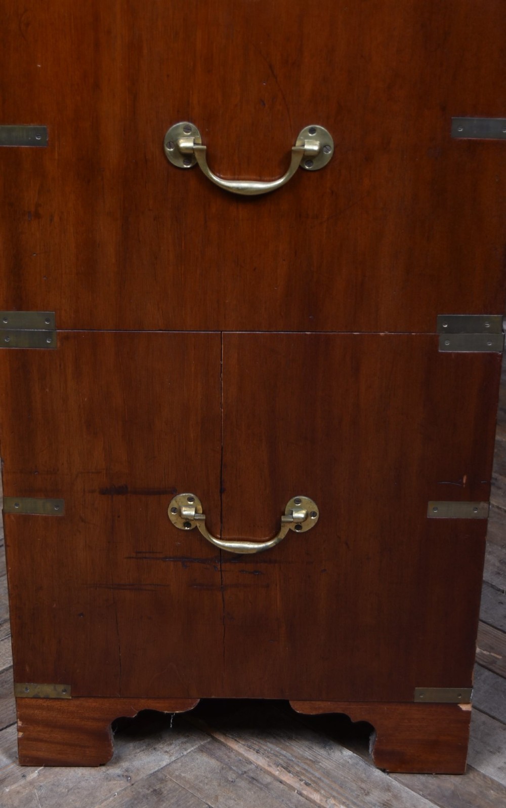 A 19th-century mahogany campaign chest of drawers featuring flush brass handles, corner brackets, and a two-section design. View IX