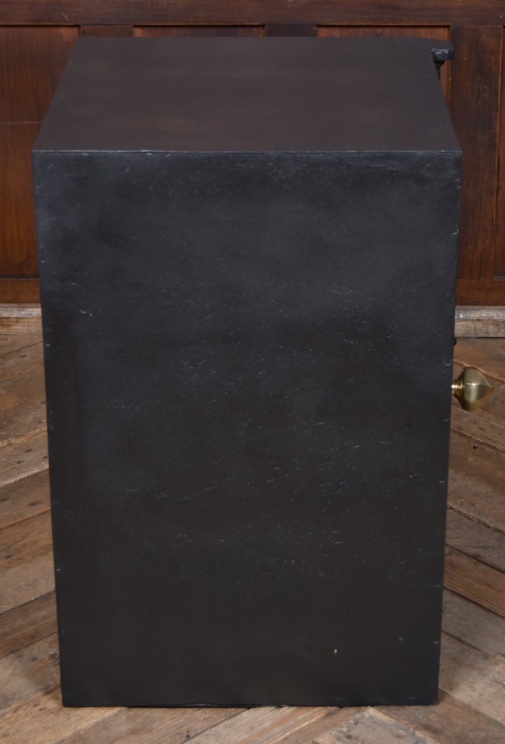 A heavy black painted iron safe featuring a rectangular body, a brass maker plaque for James Bruce of Glasgow, a faceted brass handle, and a brass fire-resisting emblem. View XI