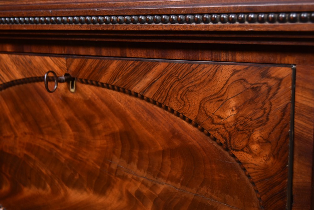 A Victorian mahogany secretaire cabinet featuring Gothic arch decorative panels, turned columns on either side, and flame mahogany veneers. View III