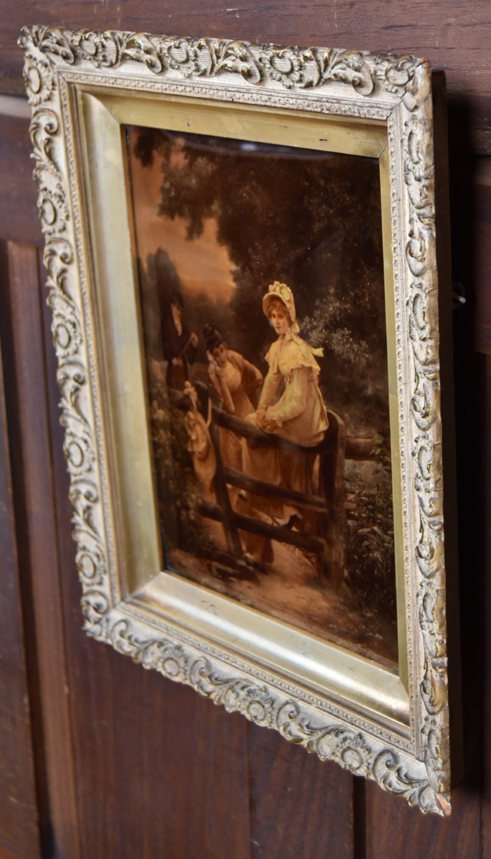A 19th-century Victorian crystoleum picture depicting figures at a countryside fence, presented in an ornate gilt frame. View V
