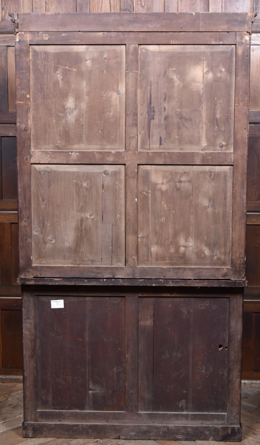 An antique two-part Georgian mahogany bookcase featuring double upper doors with diamond brass wire grilles over lower flame mahogany cupboard doors. View XI