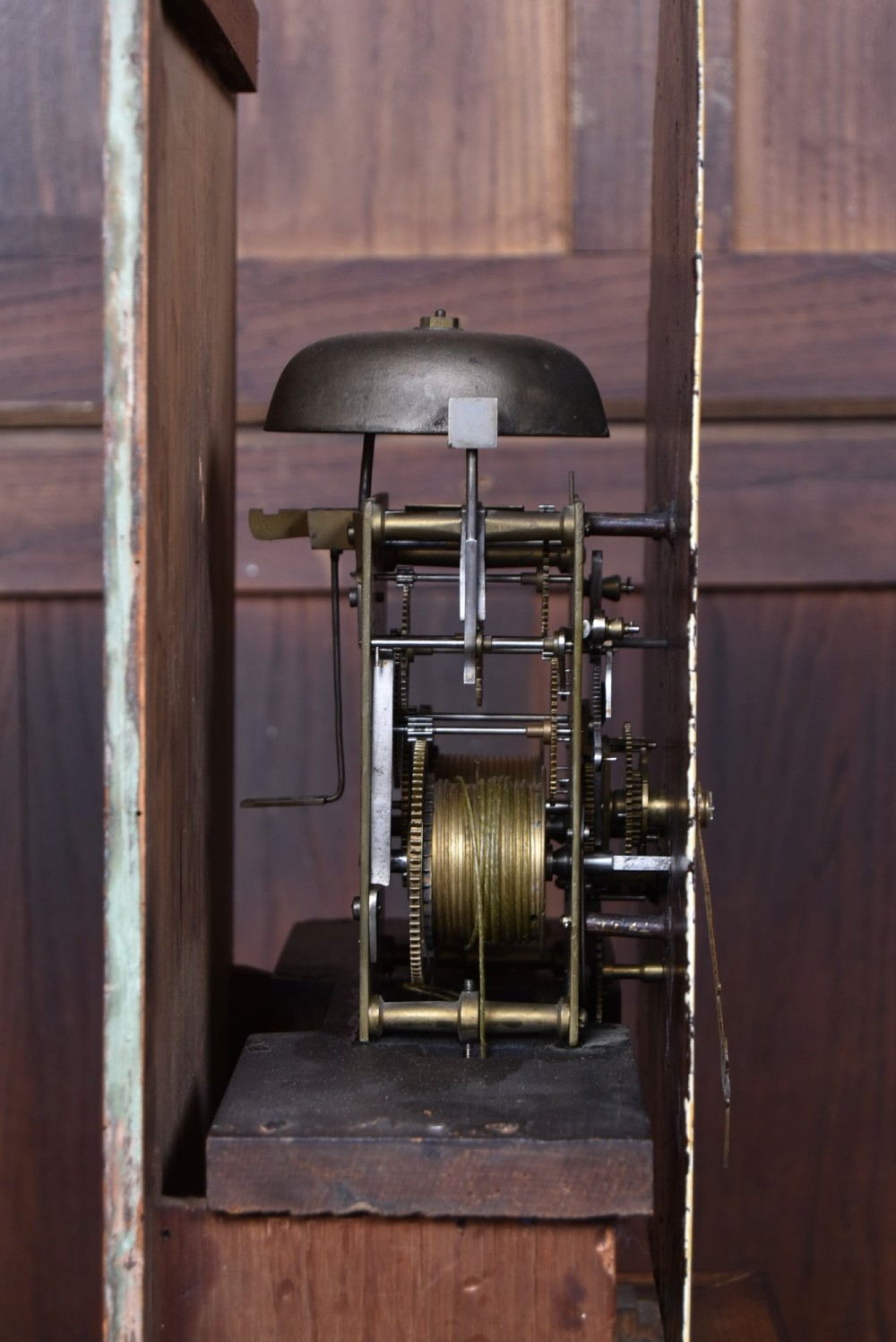 An antique Scottish flame mahogany longcase clock featuring a swan-neck pediment with brass finials and an arched painted dial. View XII