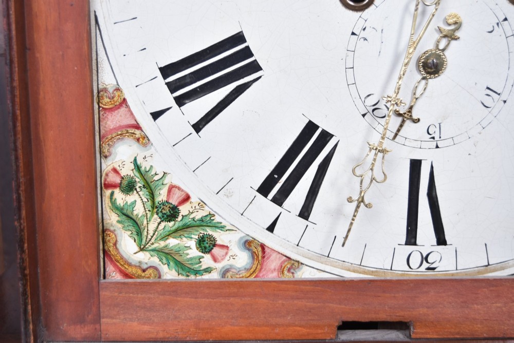 A Scottish mahogany longcase clock featuring a swan-neck pediment with brass finials, a hand-painted dial face, and flame mahogany veneers. View VIII