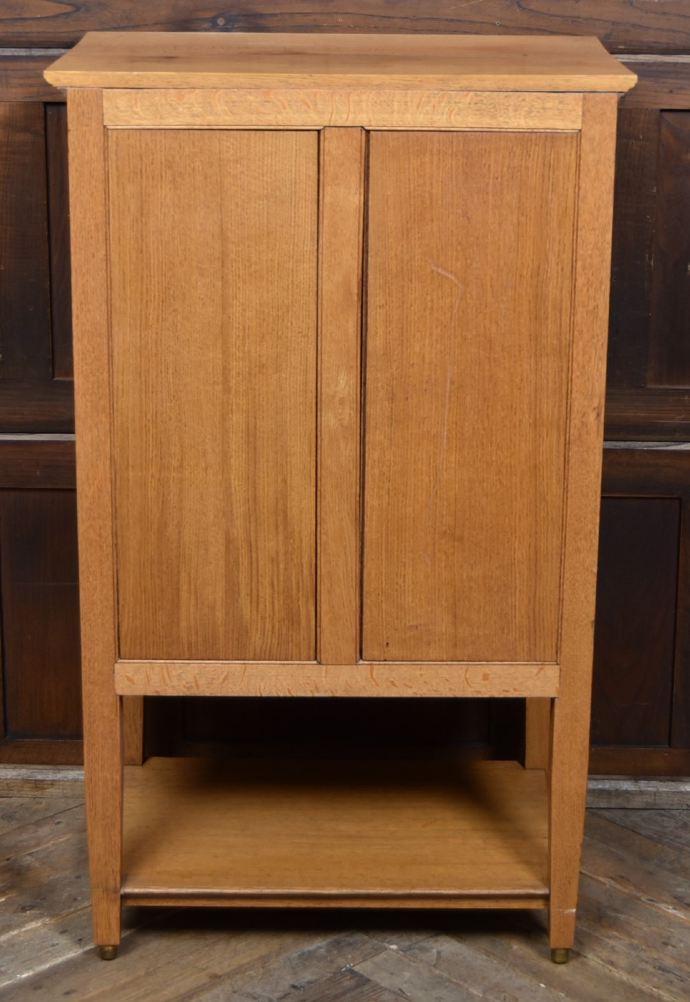 An Edwardian light oak filing cabinet with five stacked fall-front drawers featuring brass ring pulls, supported on square legs with a lower open shelf. View XIII