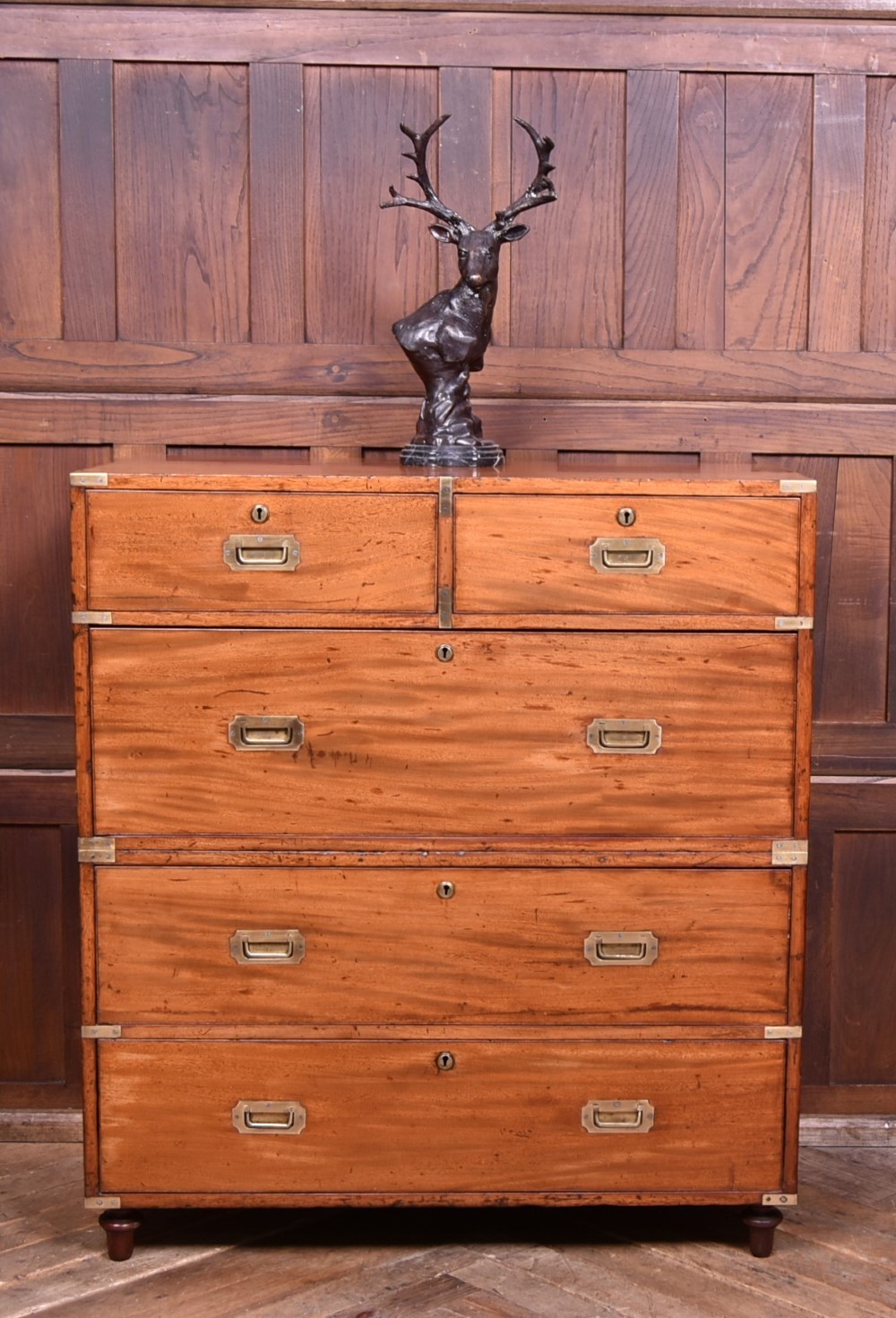 A 19th-century mahogany campaign chest of drawers with two short over three long drawers, featuring inset brass handles and brass corner straps.