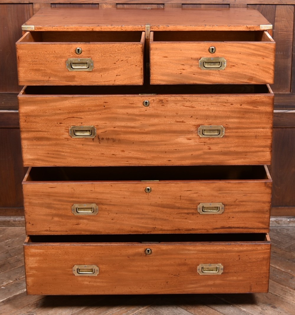 A 19th-century mahogany campaign chest of drawers with two short over three long drawers, featuring inset brass handles and brass corner straps. View IV