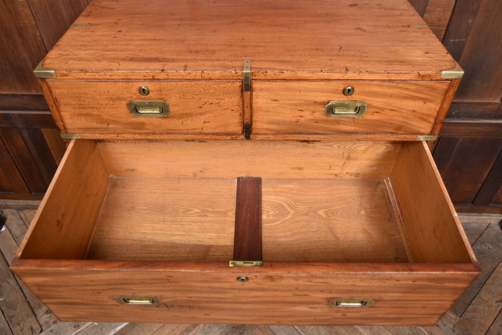 A 19th-century mahogany campaign chest of drawers with two short over three long drawers, featuring inset brass handles and brass corner straps. View V