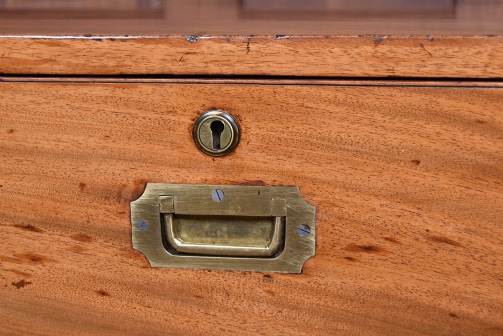 A 19th-century mahogany campaign chest of drawers with two short over three long drawers, featuring inset brass handles and brass corner straps. View VII