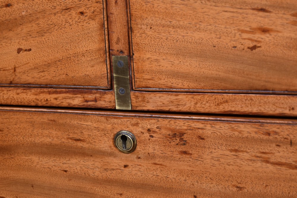 A 19th-century mahogany campaign chest of drawers with two short over three long drawers, featuring inset brass handles and brass corner straps. View VIII