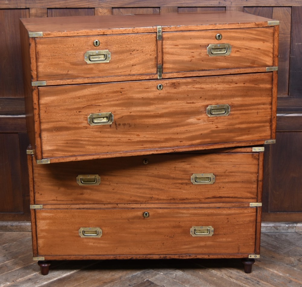 A 19th-century mahogany campaign chest of drawers with two short over three long drawers, featuring inset brass handles and brass corner straps. View IX