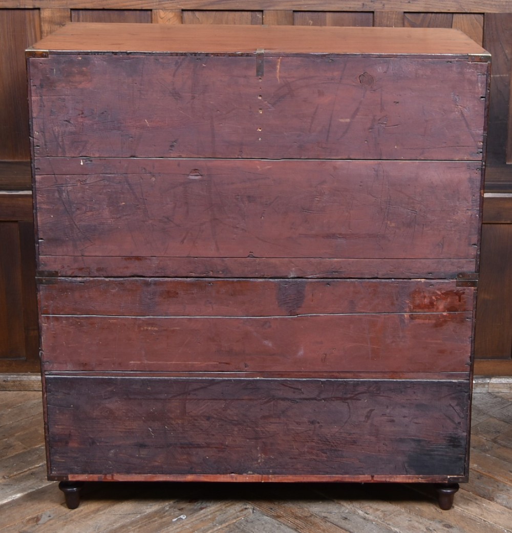 A 19th-century mahogany campaign chest of drawers with two short over three long drawers, featuring inset brass handles and brass corner straps. View XI