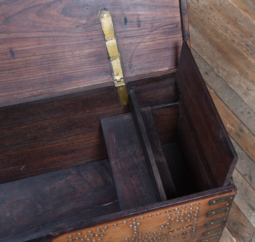 A solid padouk wood rectangular blanket box featuring intricate geometric brass stud patterns and metal strap reinforcements. View XI