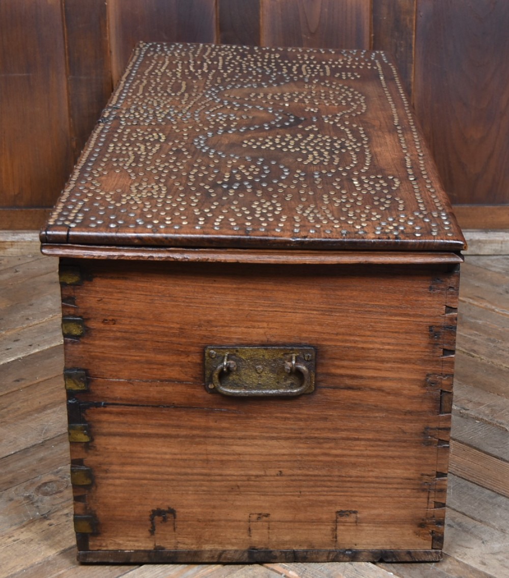 A solid padouk wood rectangular blanket box featuring intricate geometric brass stud patterns and metal strap reinforcements. View XIV