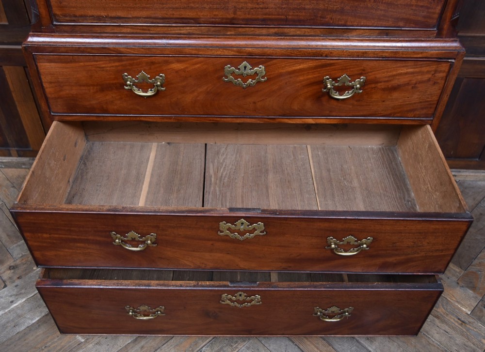 A tall Georgian mahogany chest on chest featuring two stacked tiers of drawers with brass swan-neck handles resting on bracket feet. View VII
