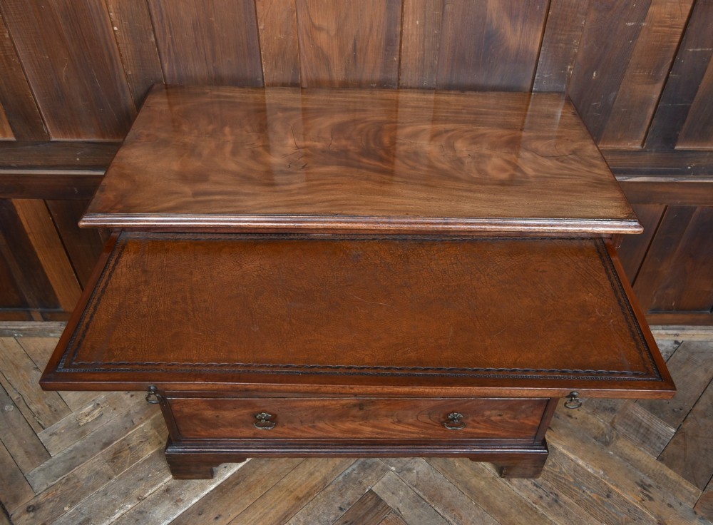 An 18th-century Georgian mahogany chest of drawers with a pull-out brushing slide, two short over three long graduated drawers, brass bail handles, and bracket feet. View VIII