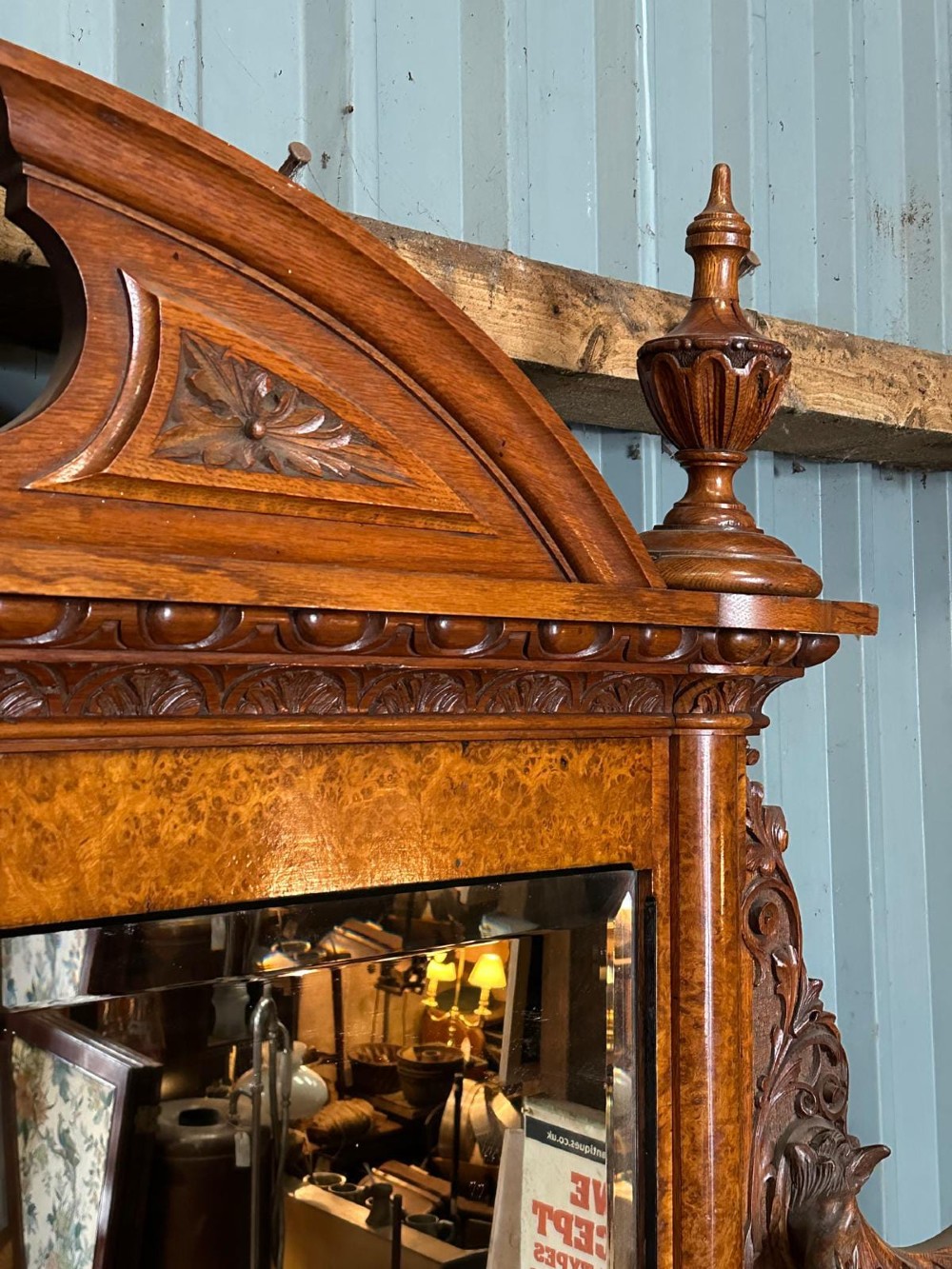 A large Victorian pollard oak mirror-back sideboard featuring carved urn finials, central mirror glass, open side shelving, and ebonised drawer borders. View II