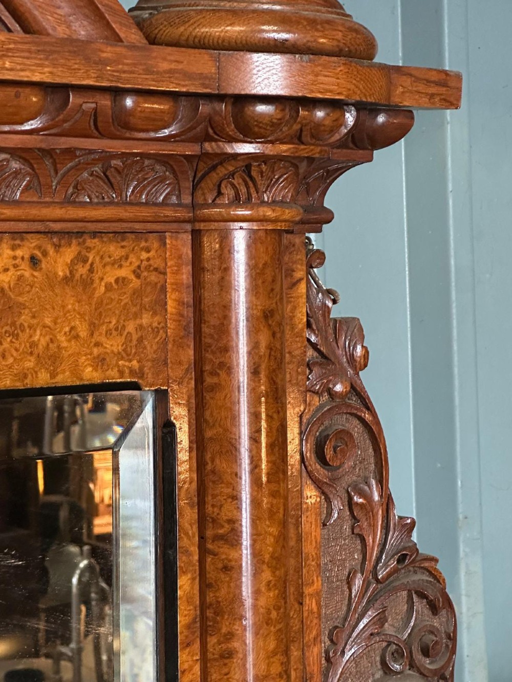 A large Victorian pollard oak mirror-back sideboard featuring carved urn finials, central mirror glass, open side shelving, and ebonised drawer borders. View III