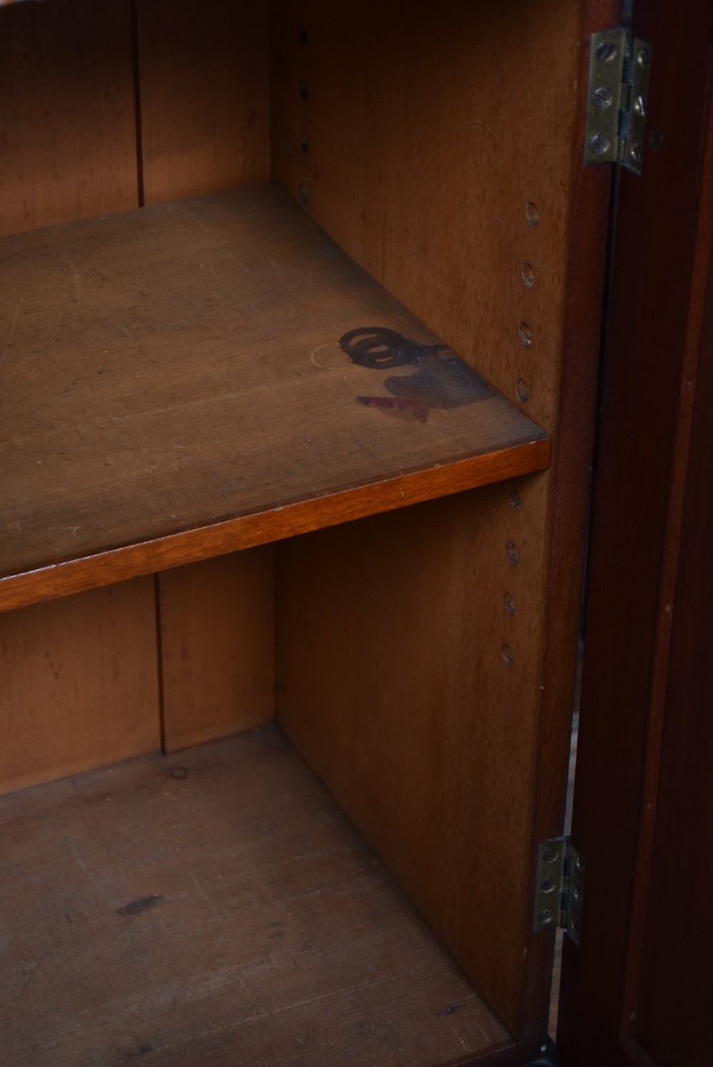A large Victorian mahogany breakfront bookcase featuring four glazed upper doors and four panelled lower cupboard doors with carved details. View V
