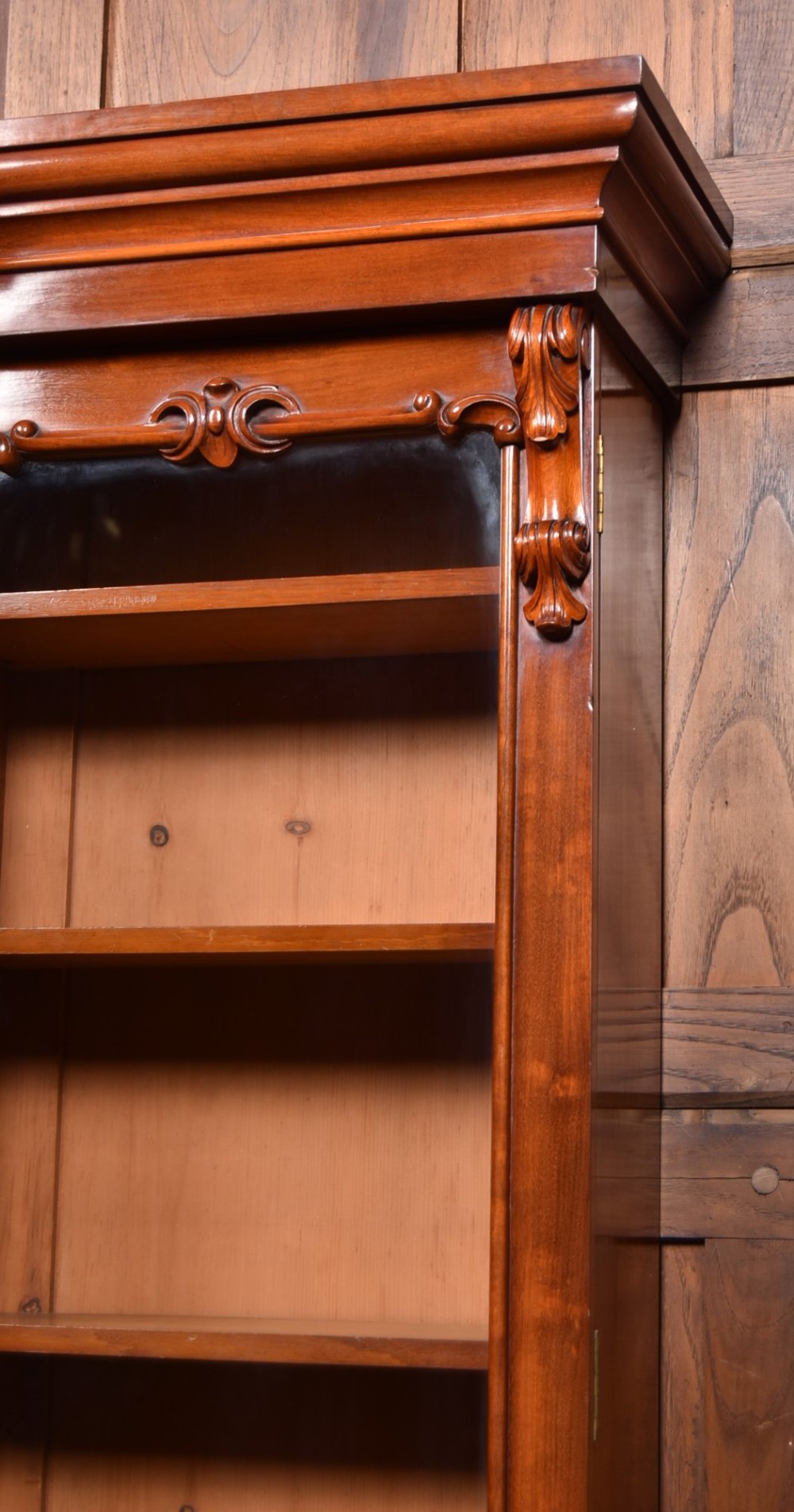 A large Victorian mahogany breakfront bookcase featuring four glazed upper doors and four panelled lower cupboard doors with carved details. View XII