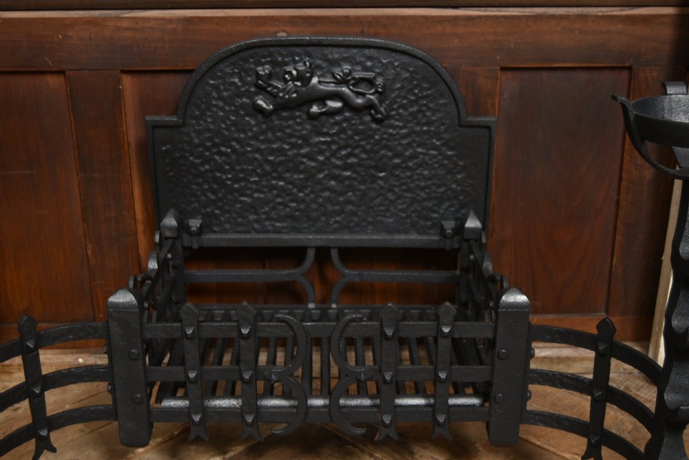 An off-white painted Neoclassical fireplace surround featuring fluted columns and swags, paired with a black cast iron fire grate. View VII