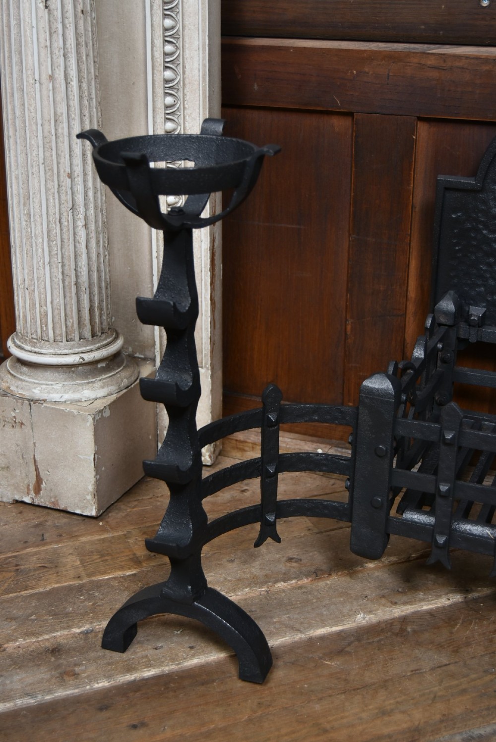 An off-white painted Neoclassical fireplace surround featuring fluted columns and swags, paired with a black cast iron fire grate. View VIII