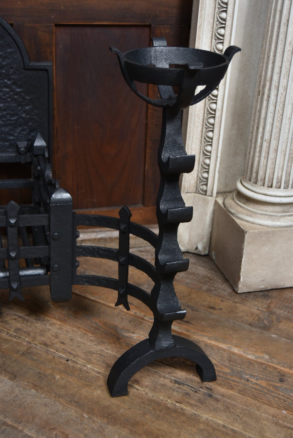 An off-white painted Neoclassical fireplace surround featuring fluted columns and swags, paired with a black cast iron fire grate. View IX