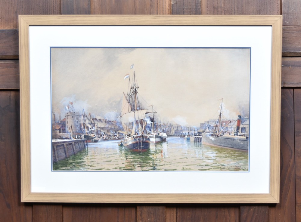 A framed watercolour painting depicting vessels and shipping in the Port of Leith harbour within a light wood frame.
