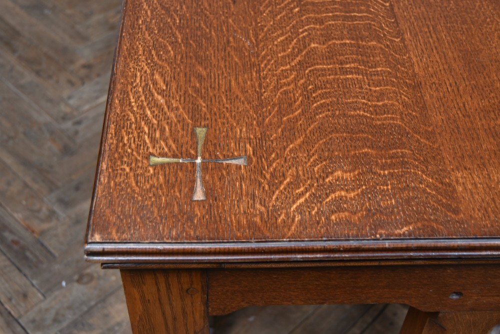 A Victorian oak church communion table with carved Gothic arch panels and a carved inscription reading Do this in Remembrance of me along the top frieze. View X