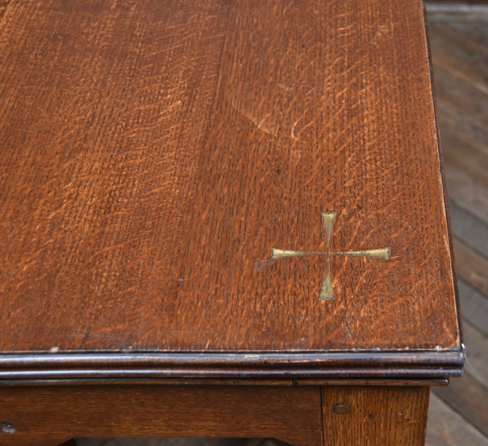 A Victorian oak church communion table with carved Gothic arch panels and a carved inscription reading Do this in Remembrance of me along the top frieze. View XI