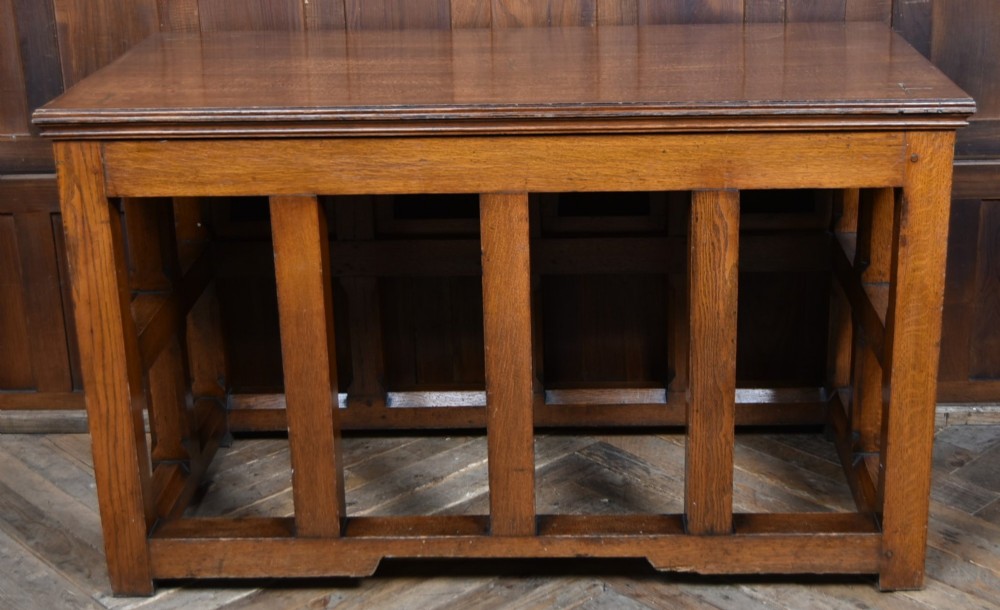 A Victorian oak church communion table with carved Gothic arch panels and a carved inscription reading Do this in Remembrance of me along the top frieze. View XII