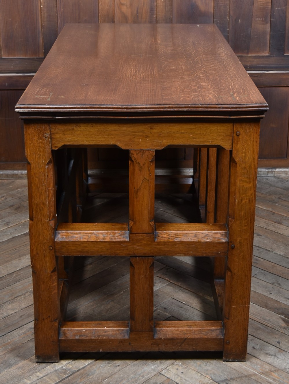A Victorian oak church communion table with carved Gothic arch panels and a carved inscription reading Do this in Remembrance of me along the top frieze. View XIII