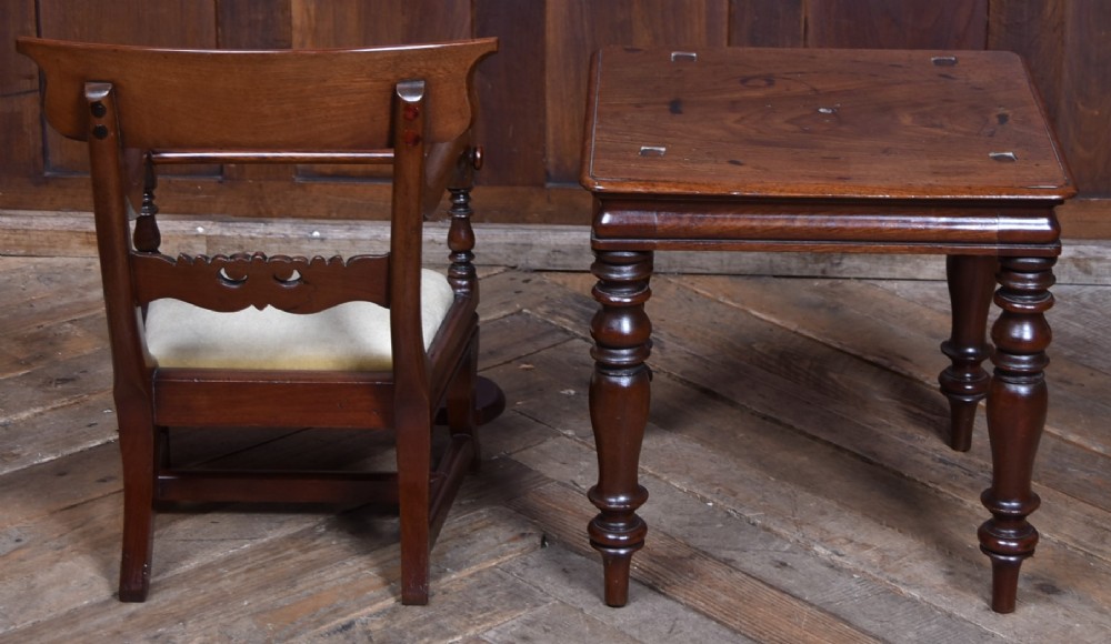 A Victorian metamorphic mahogany childs high chair with turned legs, curved armrests, a carved backrest crest, and cream fabric upholstery. View XI