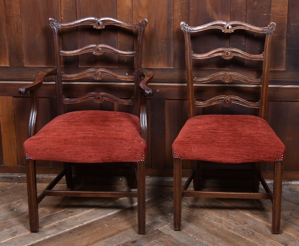 A set of Chippendale Revival mahogany dining chairs featuring carved ladder-back splats and red upholstered seats. View II