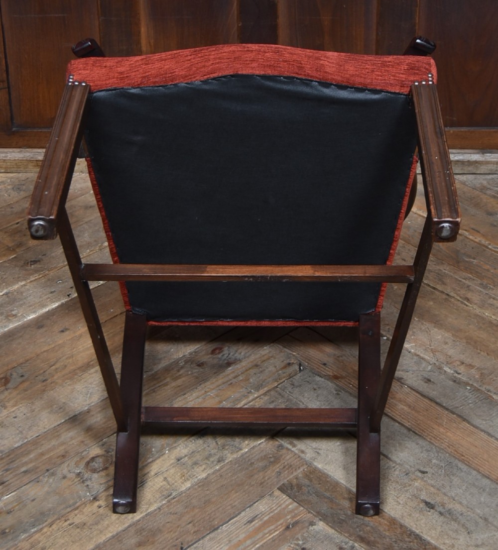A set of Chippendale Revival mahogany dining chairs featuring carved ladder-back splats and red upholstered seats. View III