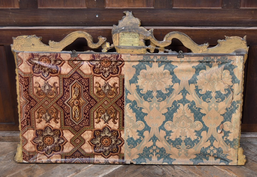 A wide Rococo style horizontal overmantel mirror with an ornate carved giltwood frame featuring an asymmetrical crest and C-scroll motifs. View X