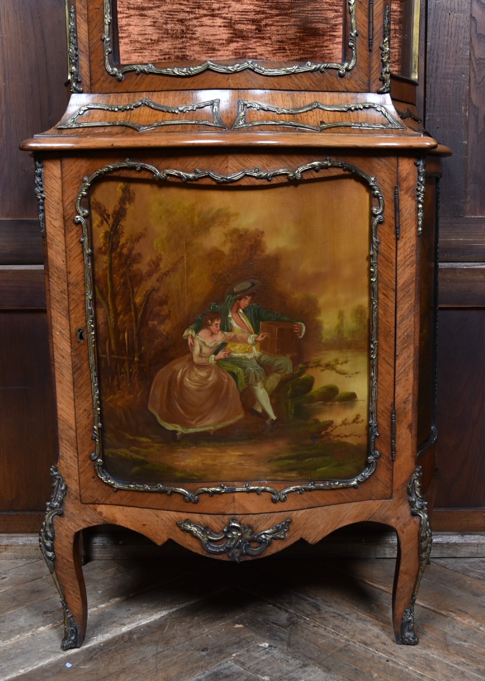 A French walnut vitrine cabinet featuring curved glass upper panels, gilt-bronze ormolu mounts, cabriole legs, and a hand-painted lower door panel depicting a figurative scene. View III
