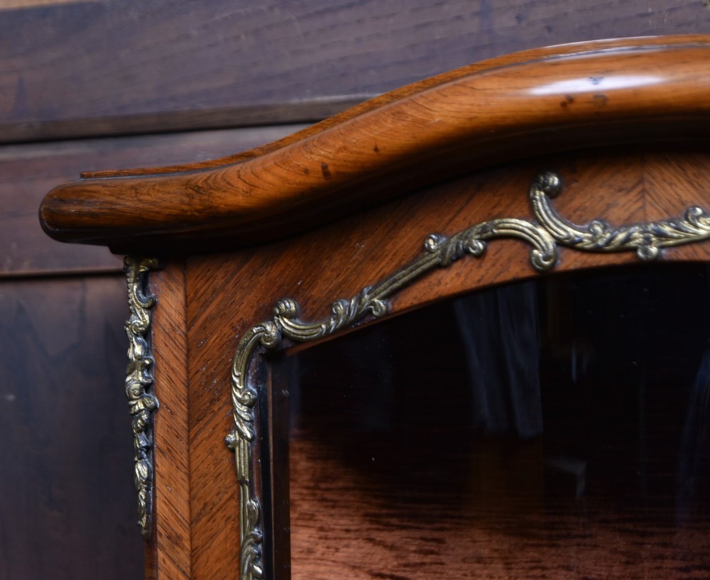 A French walnut vitrine cabinet featuring curved glass upper panels, gilt-bronze ormolu mounts, cabriole legs, and a hand-painted lower door panel depicting a figurative scene. View VII