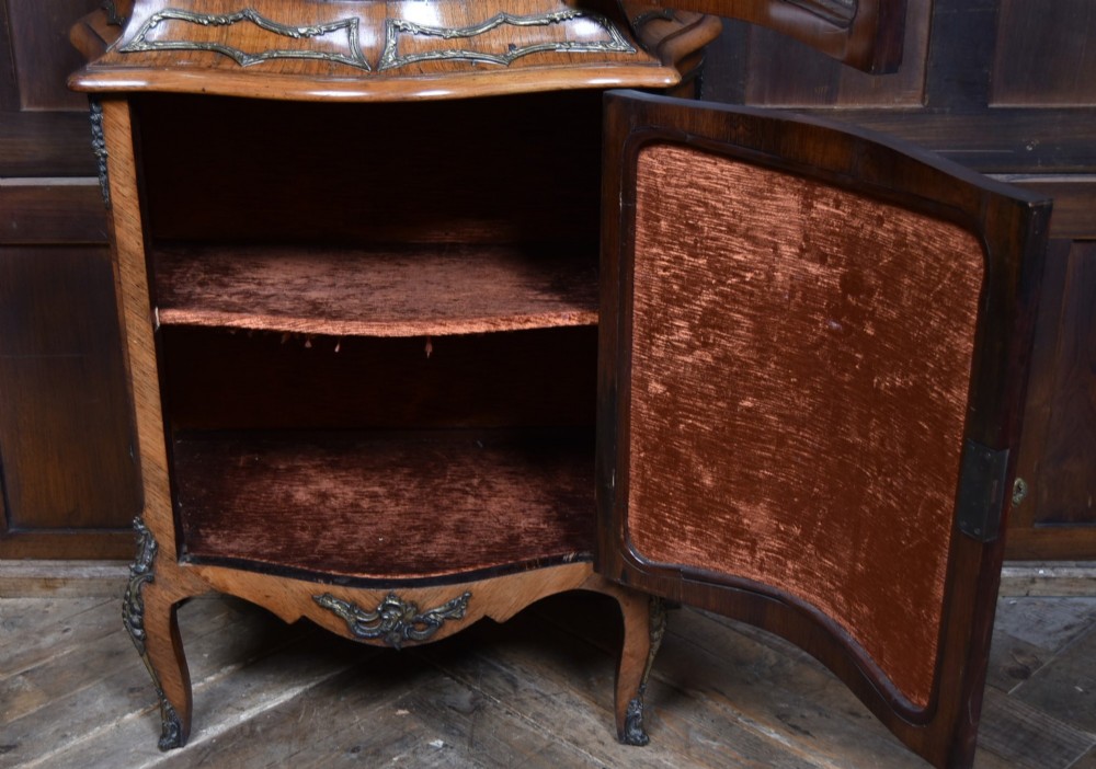 A French walnut vitrine cabinet featuring curved glass upper panels, gilt-bronze ormolu mounts, cabriole legs, and a hand-painted lower door panel depicting a figurative scene. View X