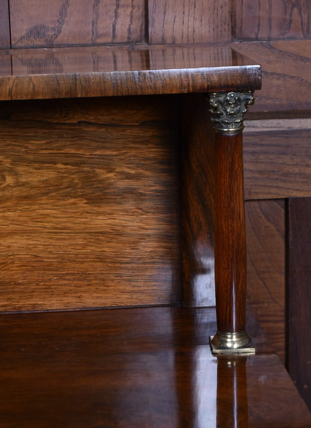 A Victorian dark rosewood chiffonier cabinet featuring a decorative brass inlay border, brass mask accents, two pleated silk fabric door panels, turned feet, and a raised upper tier shelf. View XI
