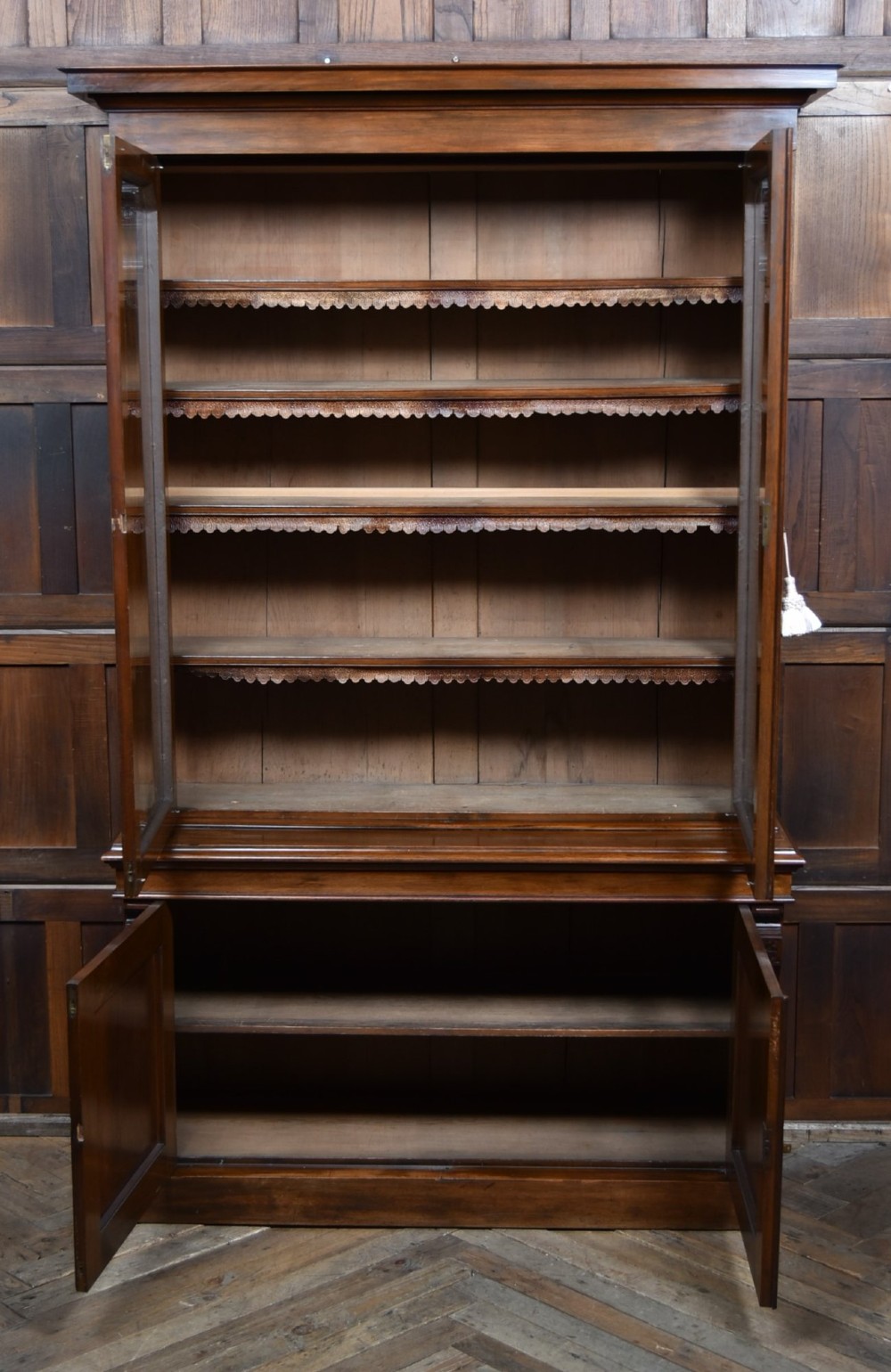 An Edwardian walnut glazed bookcase featuring a two-door upper section with glass panels, adjustable interior shelving, and a lower cabinet with burr walnut door panels. View VIII