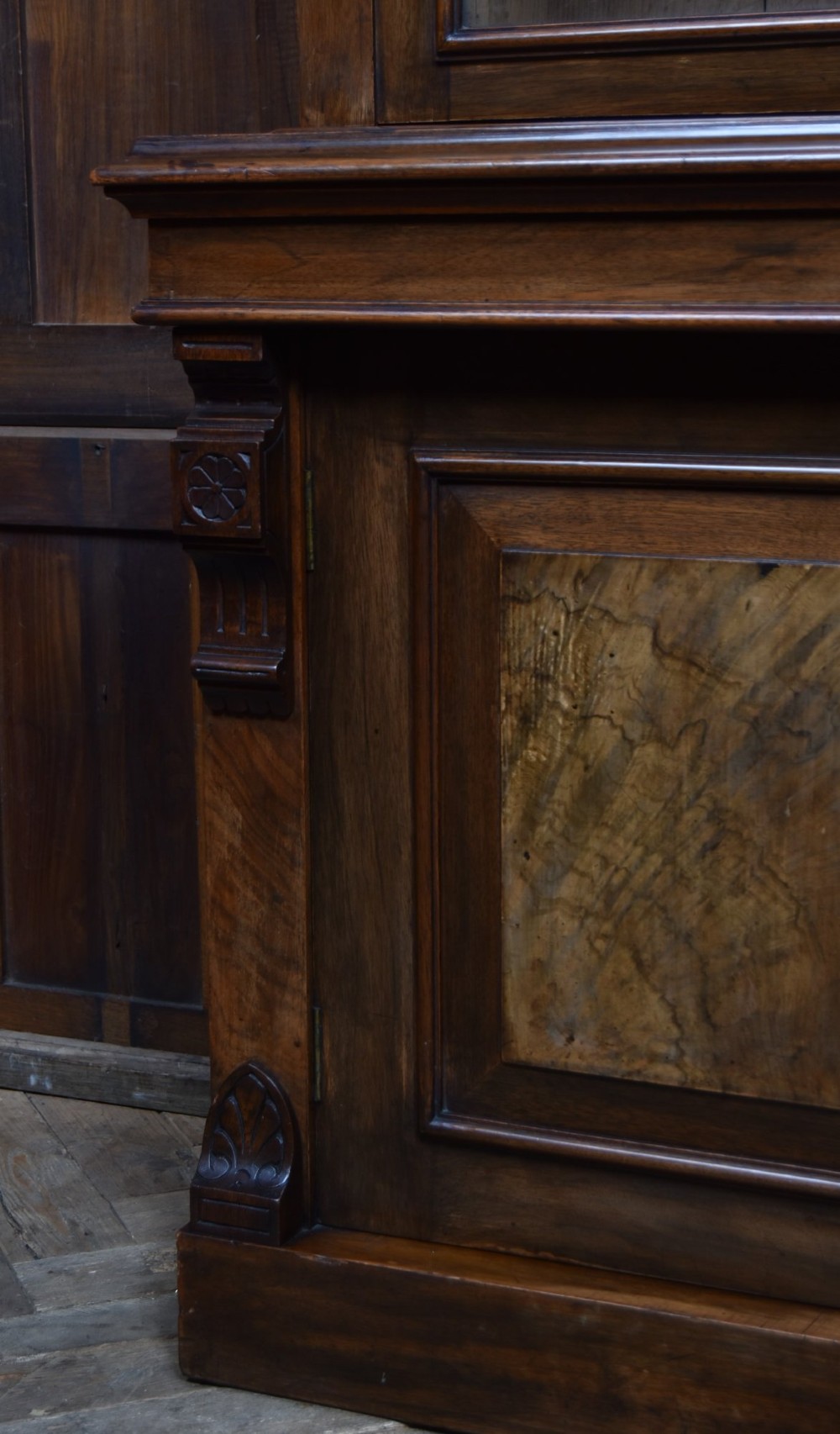 An Edwardian walnut glazed bookcase featuring a two-door upper section with glass panels, adjustable interior shelving, and a lower cabinet with burr walnut door panels. View XI