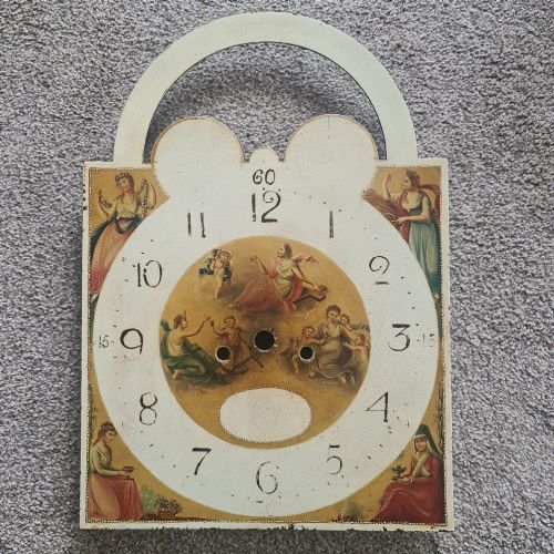 fig 8. A Regency mahogany longcase clock featuring a swan-neck pediment, a painted dial with a moonphase complication, and a Gothic arch door with flame mahogany veneers.