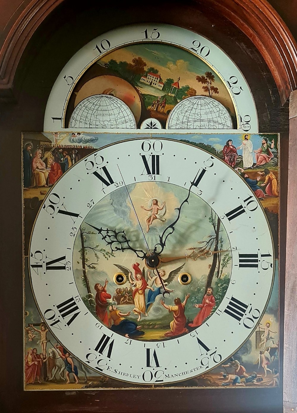 A late 18th-century Georgian mahogany longcase clock featuring a swan-neck pediment, a painted arch dial with moon phase indicator, and a gothic shaped trunk door. View III