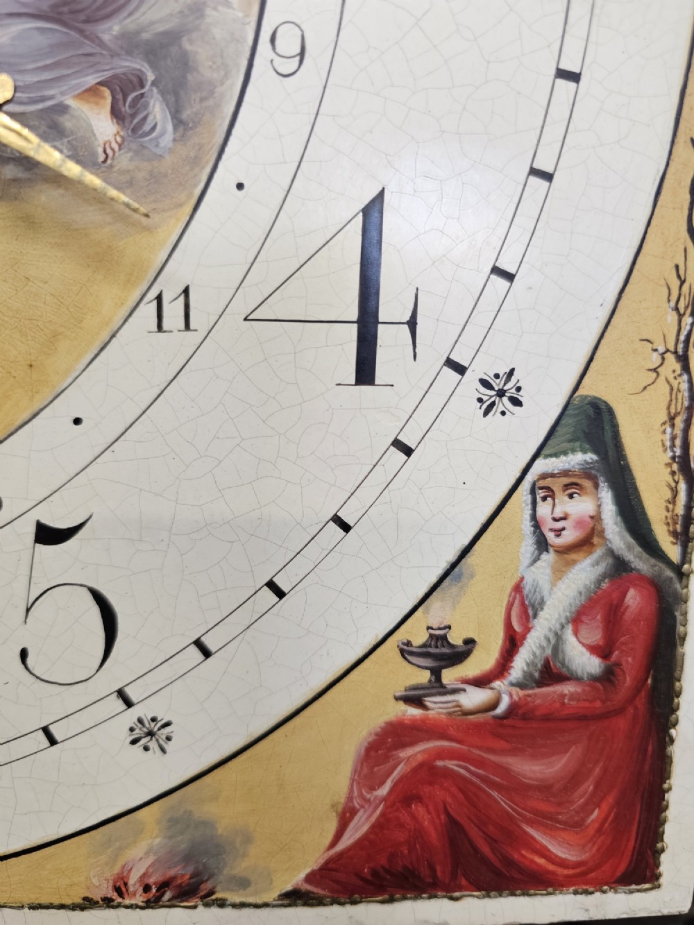 A Regency mahogany longcase clock featuring a swan-neck pediment, a painted dial with a moonphase complication, and a Gothic arch door with flame mahogany veneers. View XII