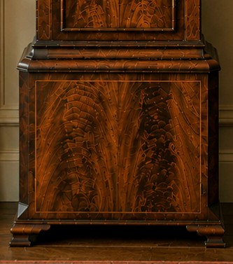 A Regency mahogany longcase clock featuring a swan-neck pediment, a painted dial with a moonphase complication, and a Gothic arch door with flame mahogany veneers. View XV