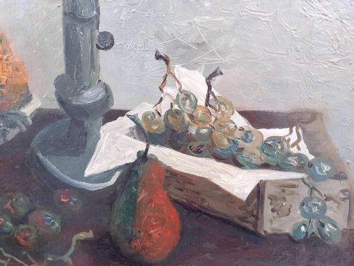 fig 3. A mid-century French modernist oil painting on canvas depicting a ceramic bowl with pears, bunches of grapes, and a candlestick on a table against a textured grey background.