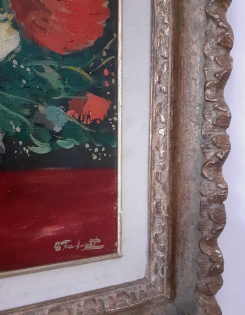 fig 1. A framed oil painting on canvas depicting a bouquet of yellow and red flowers in a glass vase set on a dark red table surface.