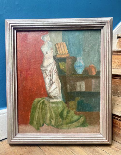 fig 1. A framed oil painting on board depicting a classical draped torso sculpture set against a split red and blue interior background.
